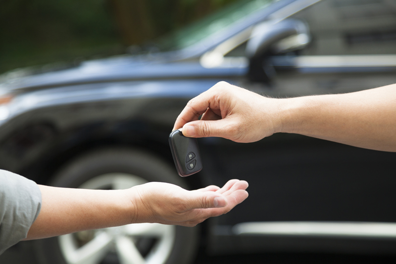 hands giving and receiving car key